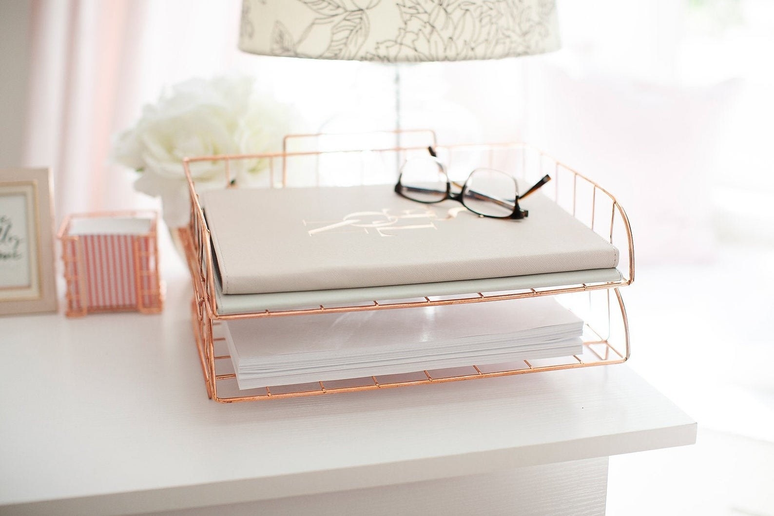 Rose gold wire drawer placed on desk
