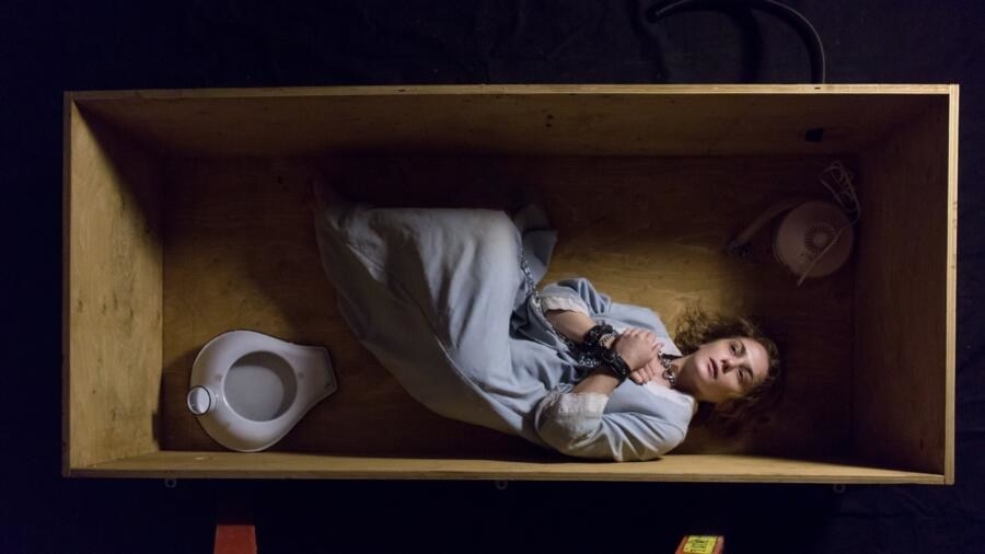 Collen Stan laying in a box