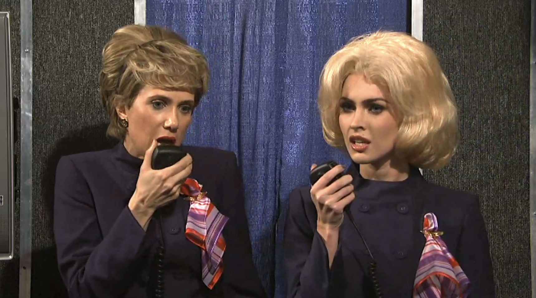 Two people dressed as flight attendants in an &quot;SNL&quot; sketch