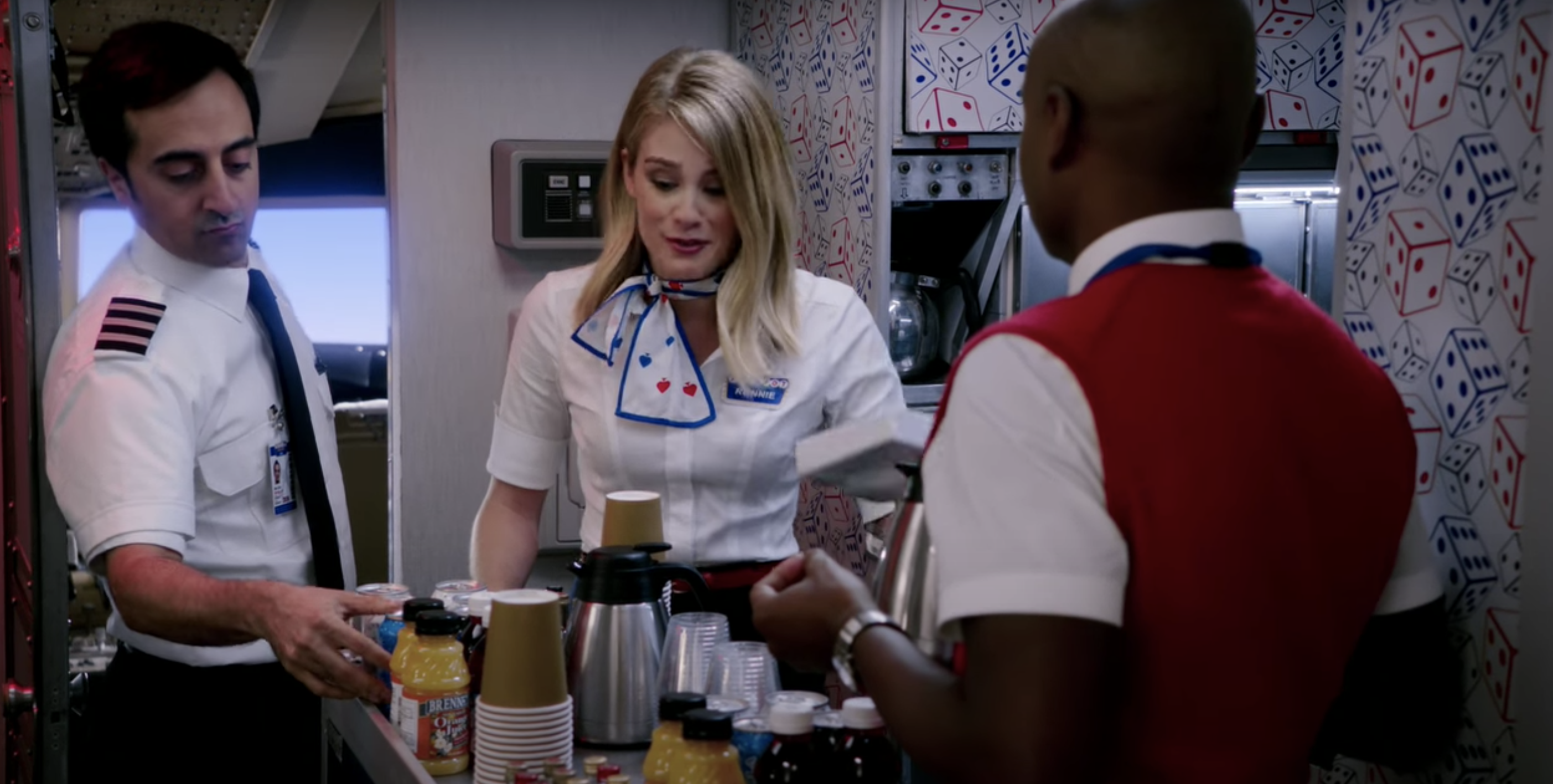 Flight attendants talking while prepping drinks