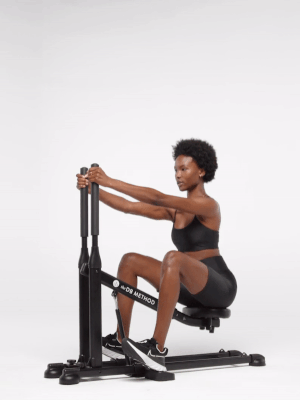a gif of a model using the squat machine