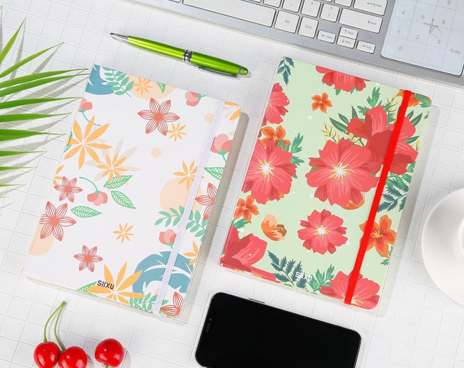 Two vibrant journals on a desk 