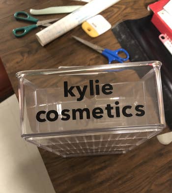 a plastic container with a black label on it that says kylie cosmetics