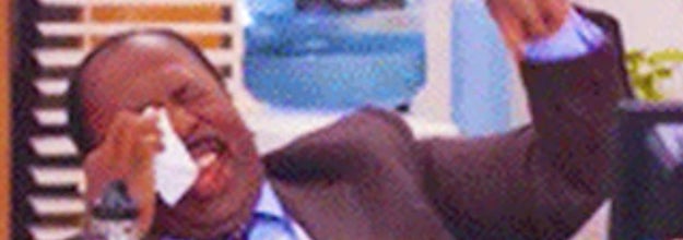 Stanley from the Office laughing and wiping his eye