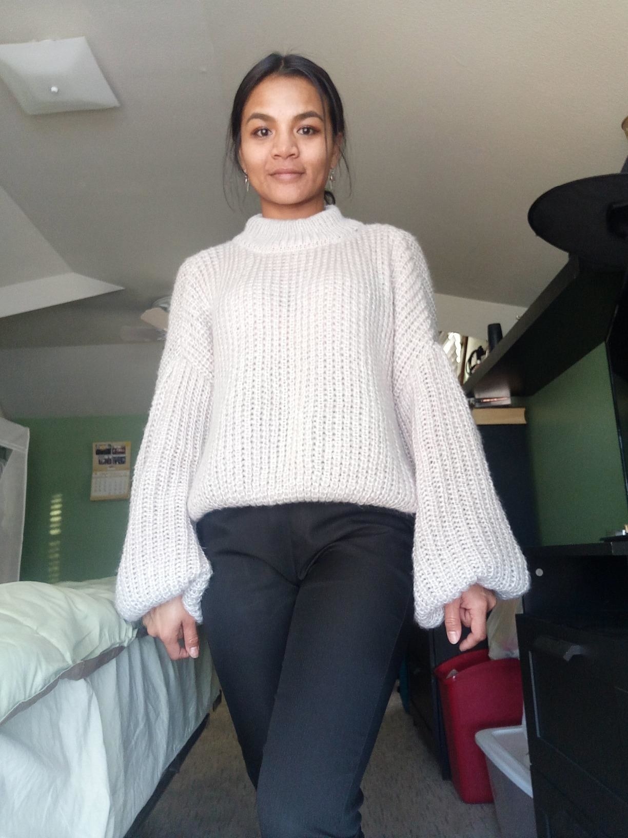Reviewer wearing gray sweater