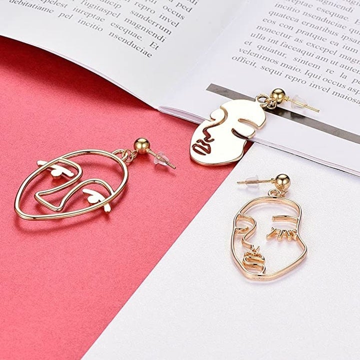 the three different kinds of face earrings that come in the set