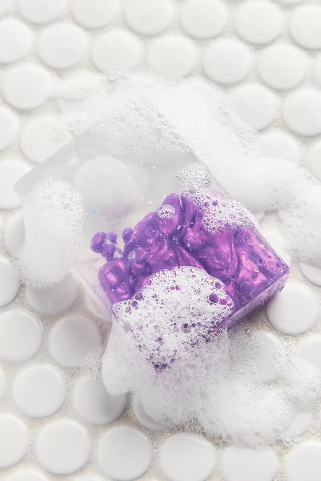 clear soap with blobs of iridescent purple inside 