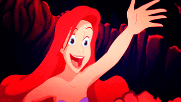 a gif of ariel from the little mermaid waving hello