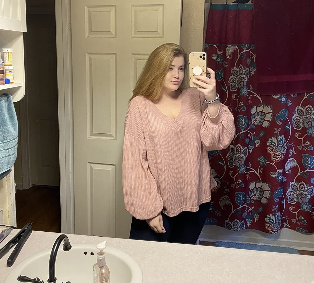 The top in pink worn by an Amazon reviewer taking a bathroom selfie