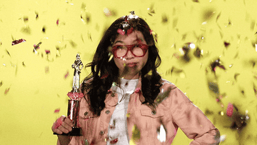 Awkwafina is showered in confetti. 