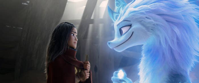 A scene from Raya and the Last Dragon featuring Raya and a dragon looking at each other