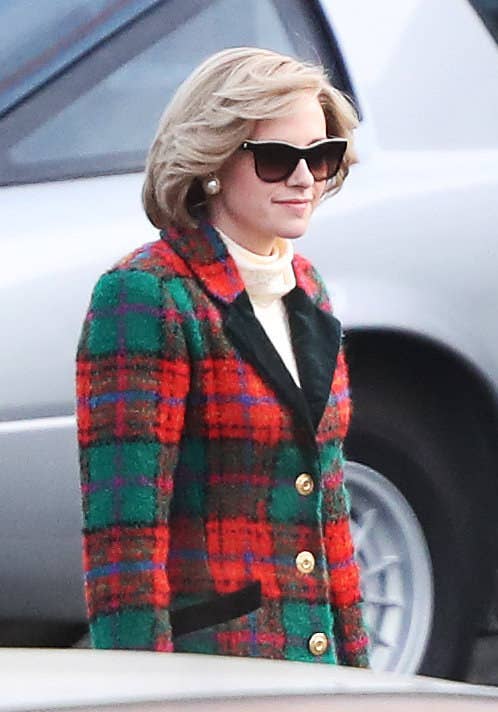 Kristen wearing a plain tweed jacket with large buttons and skirt and sporting short blonde hair