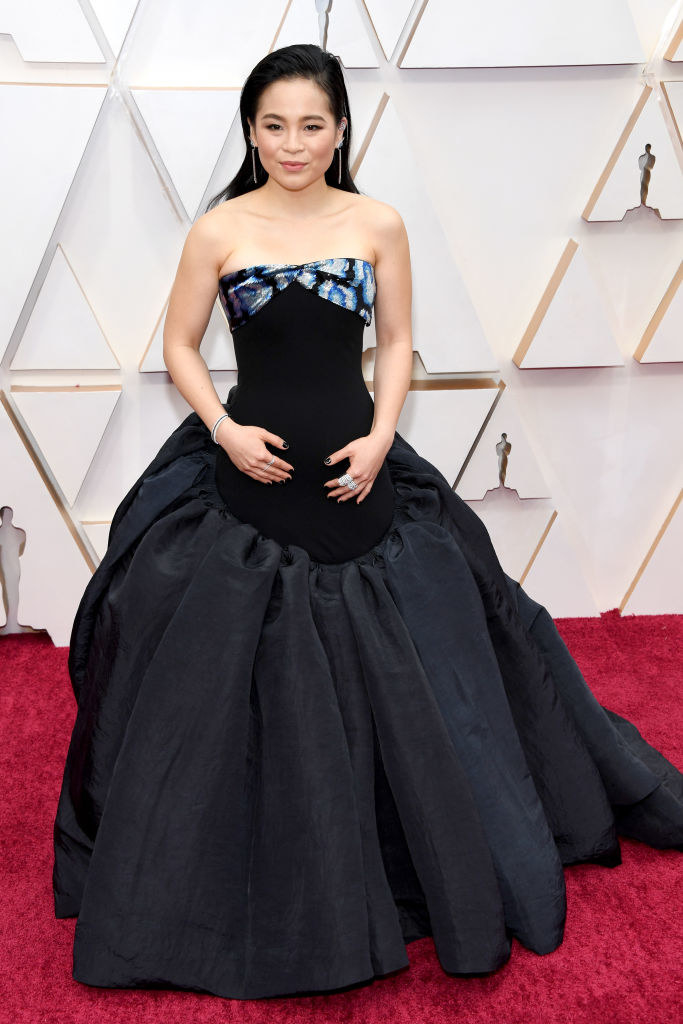 Kelly posing on the Oscars red carpet in a sleeveless ballgown 