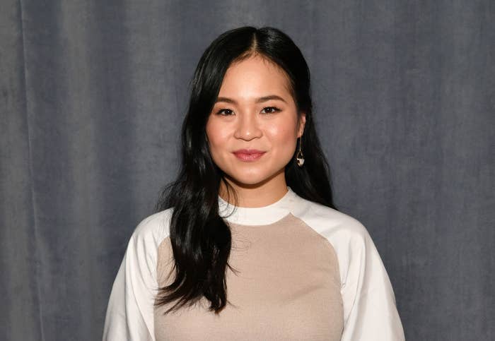Kelly Marie Tran posing in a two-toned outfit at an event