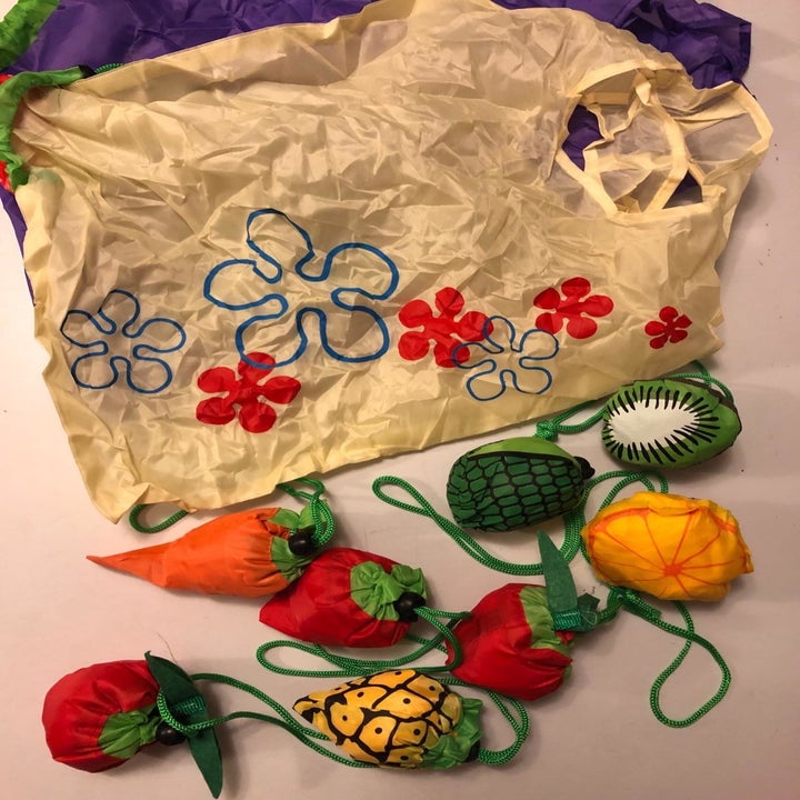 reviewer image of one of the bags unfolded and another seven bags rolled up to look like different fruits