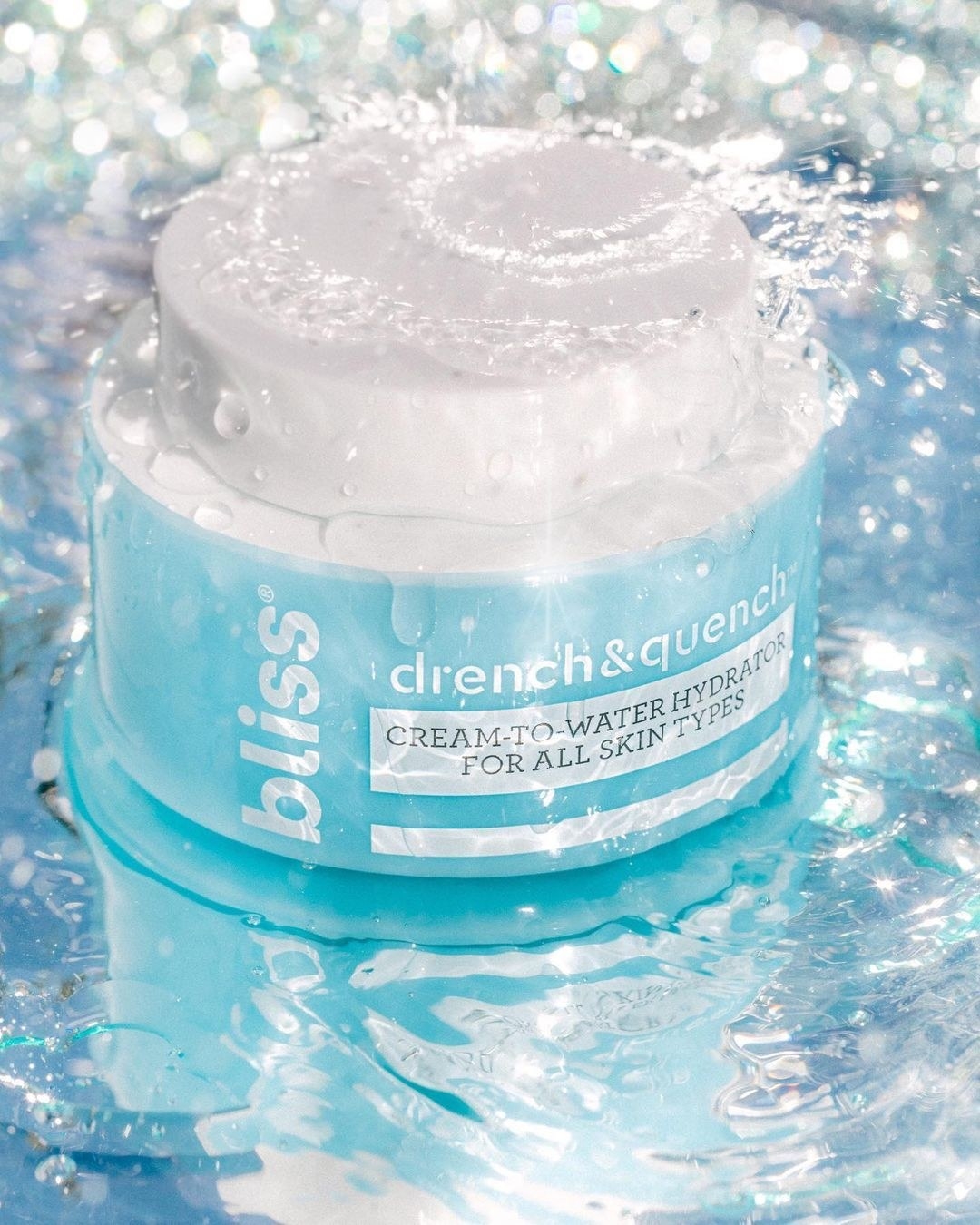 A blue jar of moisturizing cream in splashing water