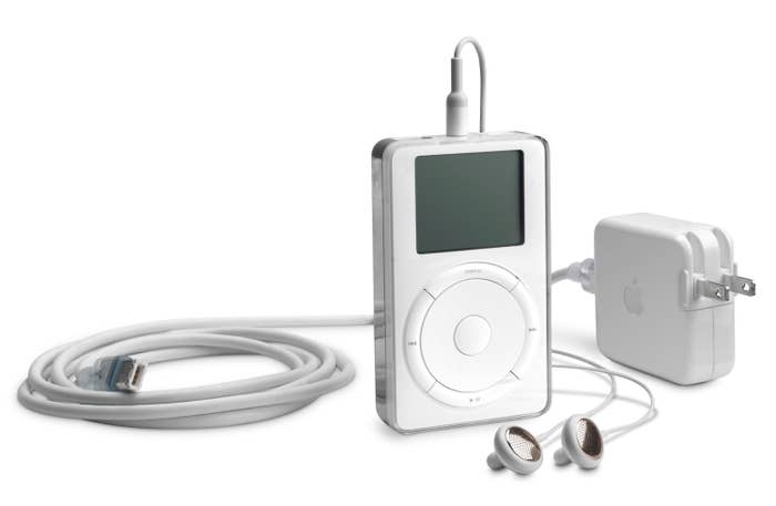 A press photo of the very first iPod alongside a the headphones and power adaptor