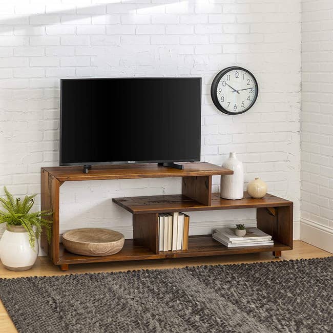 amber TV stand styled with books and other decor
