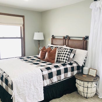 side view of a reviewer's brown headboard mounted to the wall