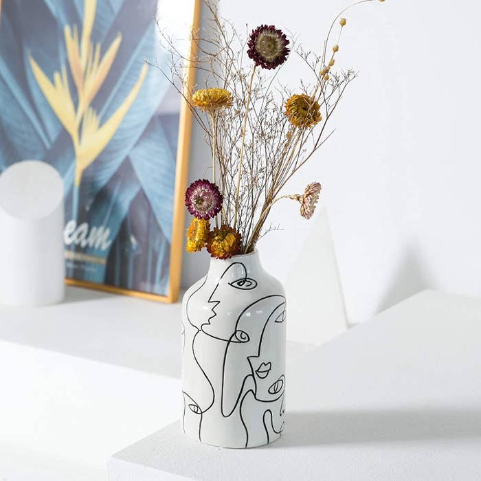 the white etched vase with a bouquet of dried flowers