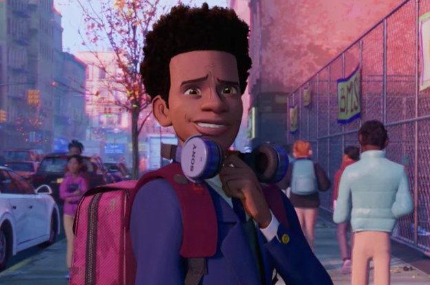 miles morales smiles with large headphones resting on his shoulders