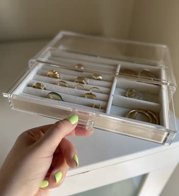 buzzfeed editor pulling out the top drawer which holds rings