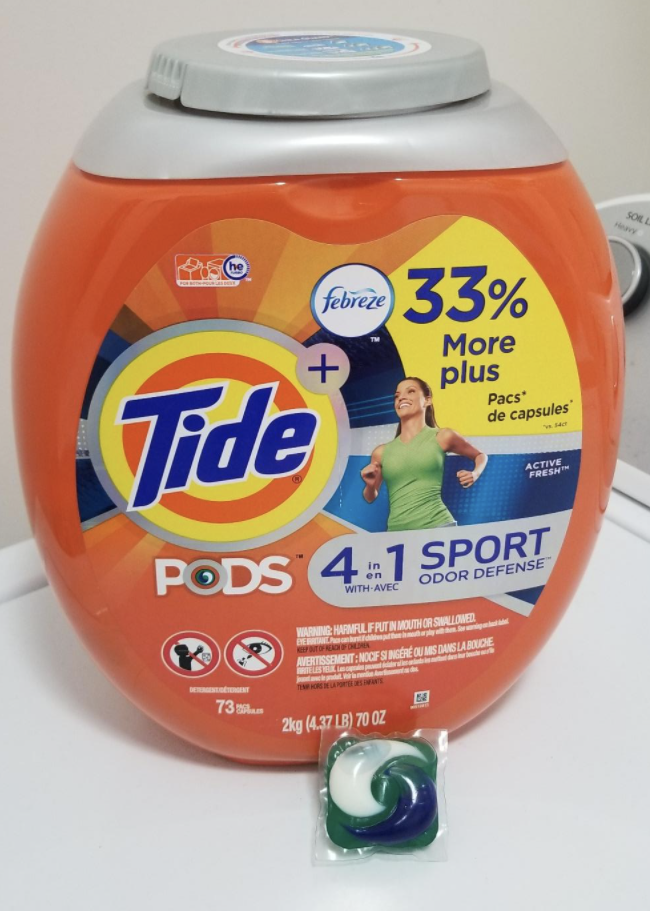 reviewer pic of the orange container and small square tide pod sitting below it