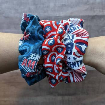 a model wearing three captain america inspired scrunchies