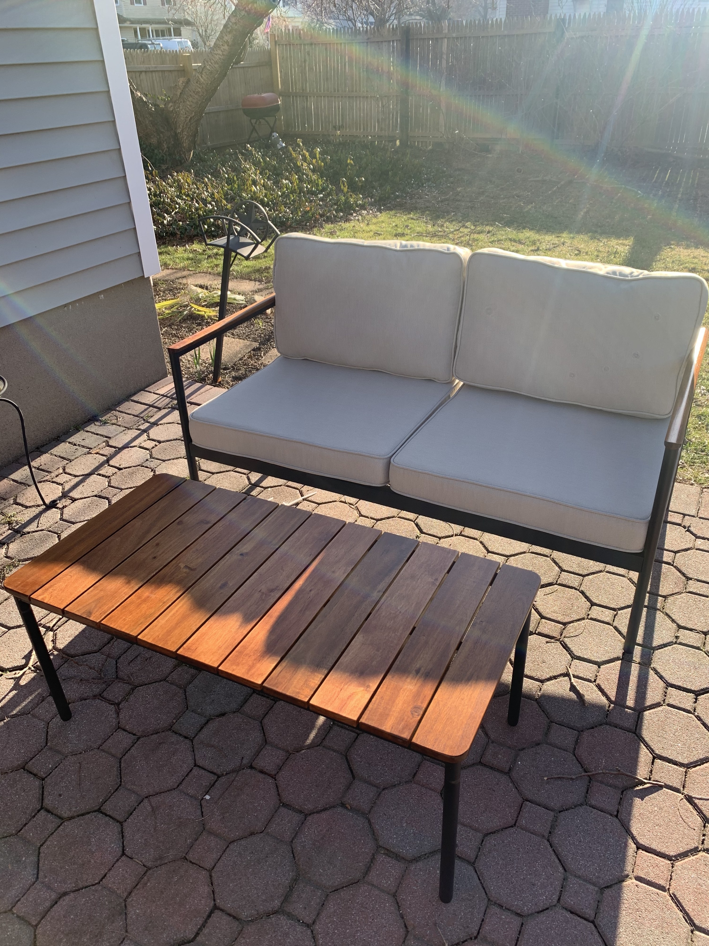 patio with wooden coffee table and cushioned love seat