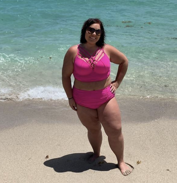 reviewer wearing swimsuit in pink
