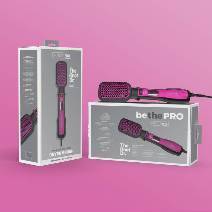 Product image of Knot Dr.® All-In-One Smoothing Dryer Brush; the opened brush lays atop its packaging. 