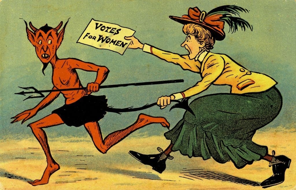 A woman chasing the devil with a sign that says, &quot;Votes for women&quot;