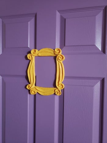 a closer up photo of a reviewer's door with the yellow frame on it