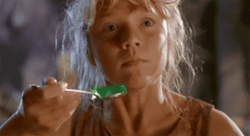 Lex in jurassic park holding a spoonful of jell-o and shaking in fear