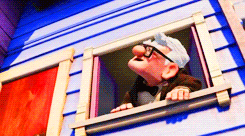 a gif of carl from up raising his hands in the air while the house floats away