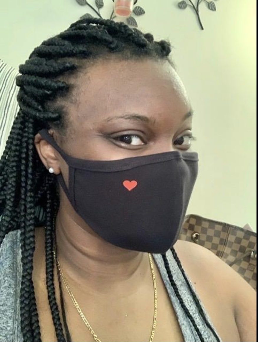 Reviewer in black face mask with subtle red heart on the right top side 