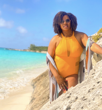 reviewer wearing the swimsuit in golden yellow