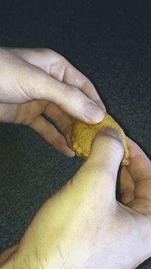 The writer pulls apart a pizza bite to show the inside