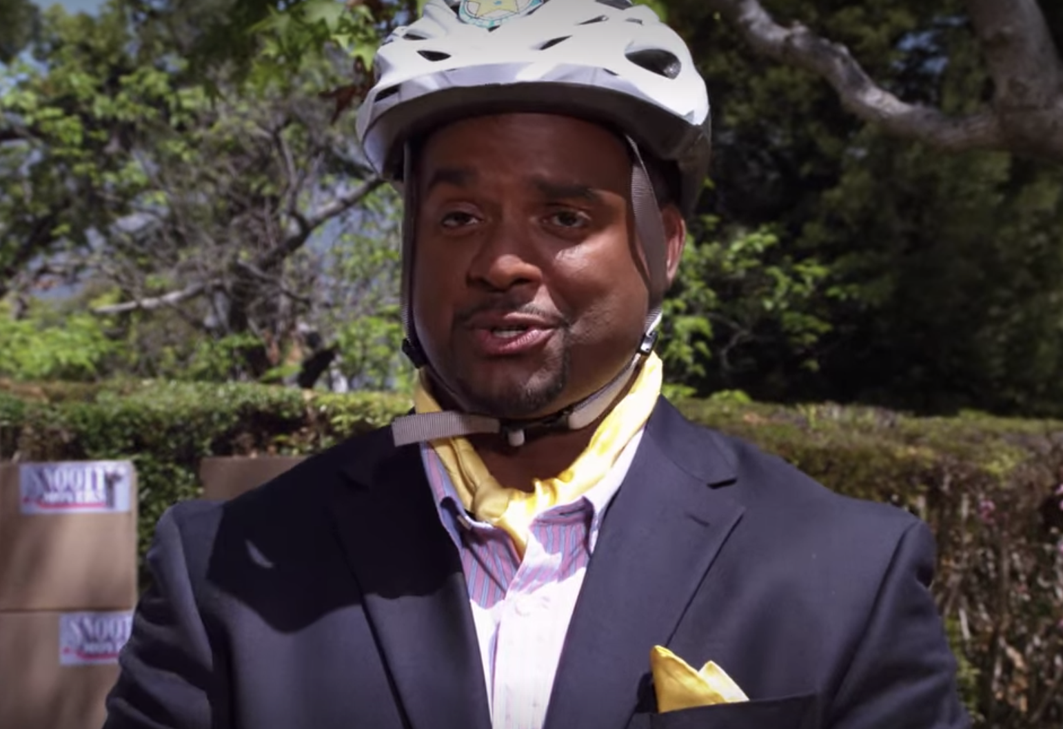 Alfonso Ribeiro riding with a helmet on a segway