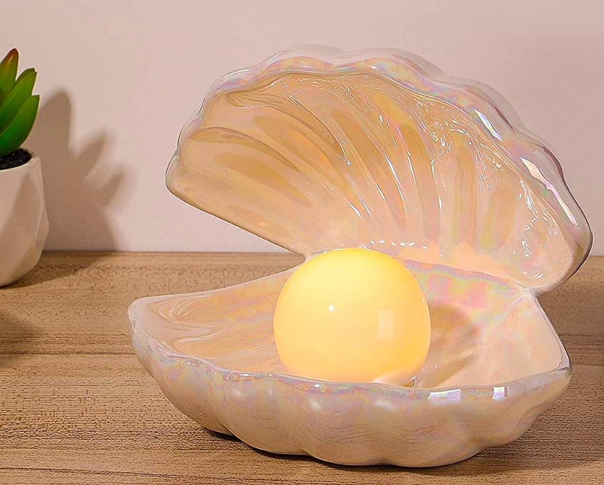 Iridescent shell base with glowing round pearl light inside 
