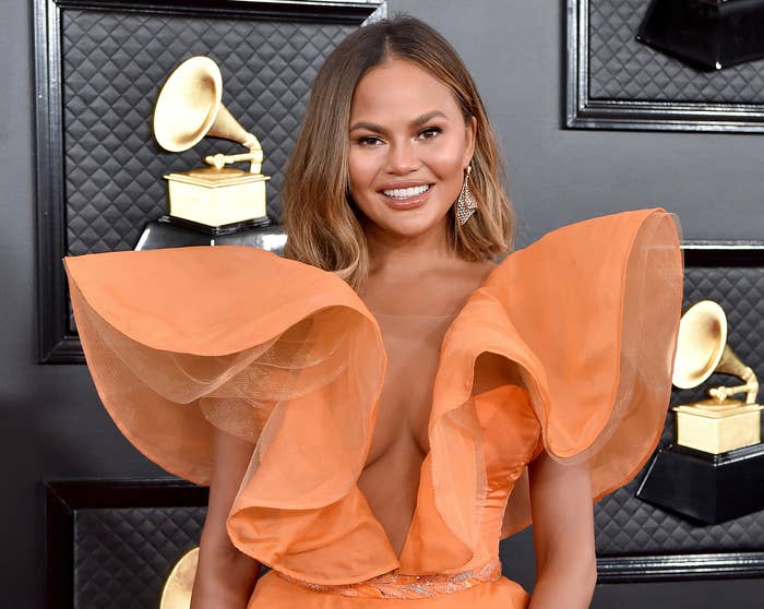 Chrissy wears a ruffled orange dress at an awards show last year