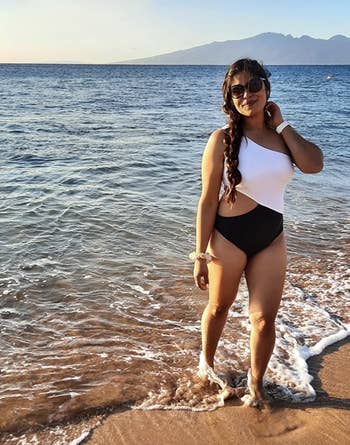 reviewer wearing the swimsuit in white and black