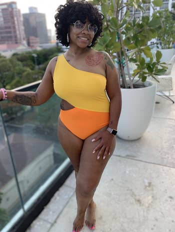 reviewer wearing the swimsuit in yellow and orange