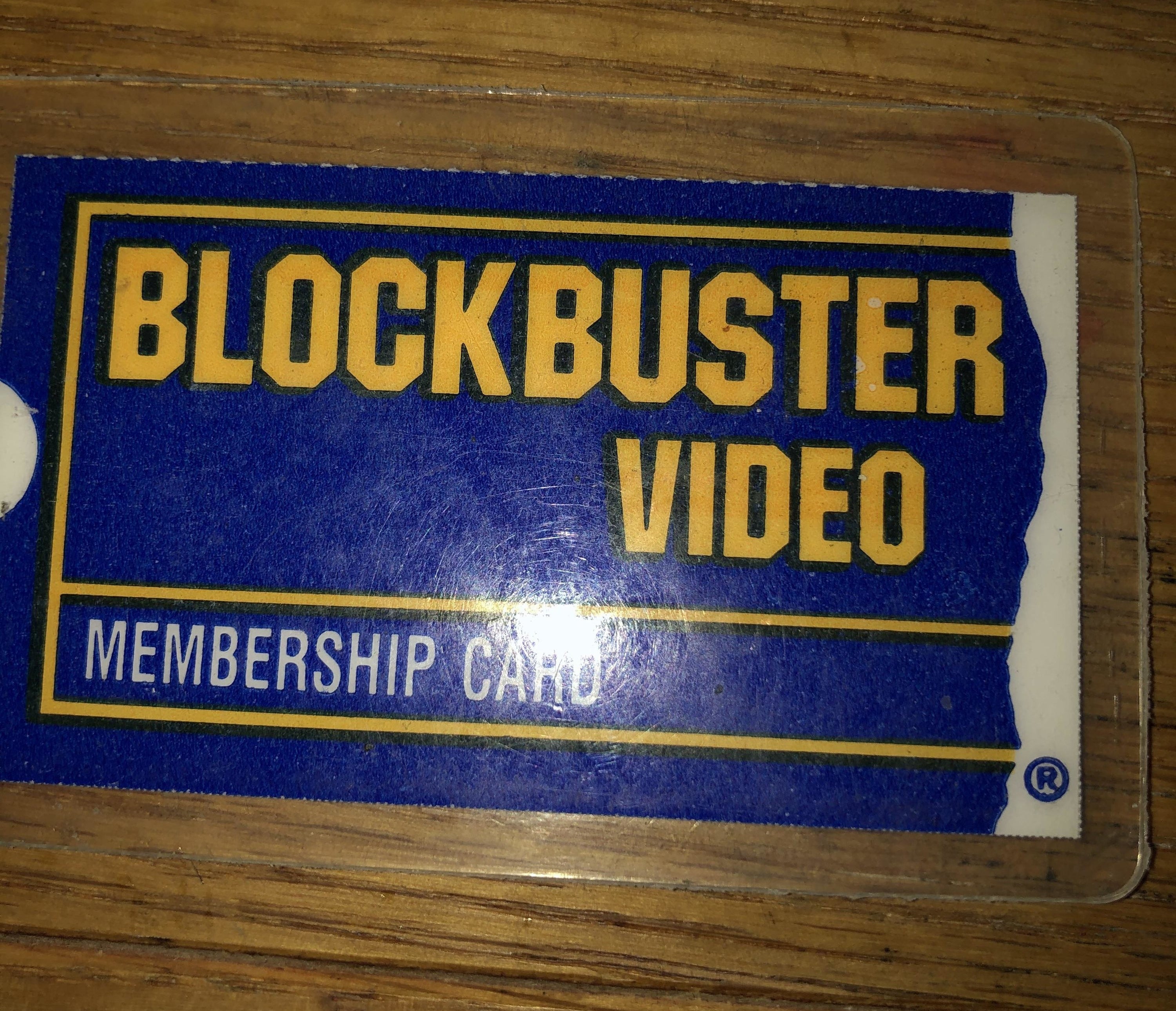 A Blockbuster Video card on a wooden table