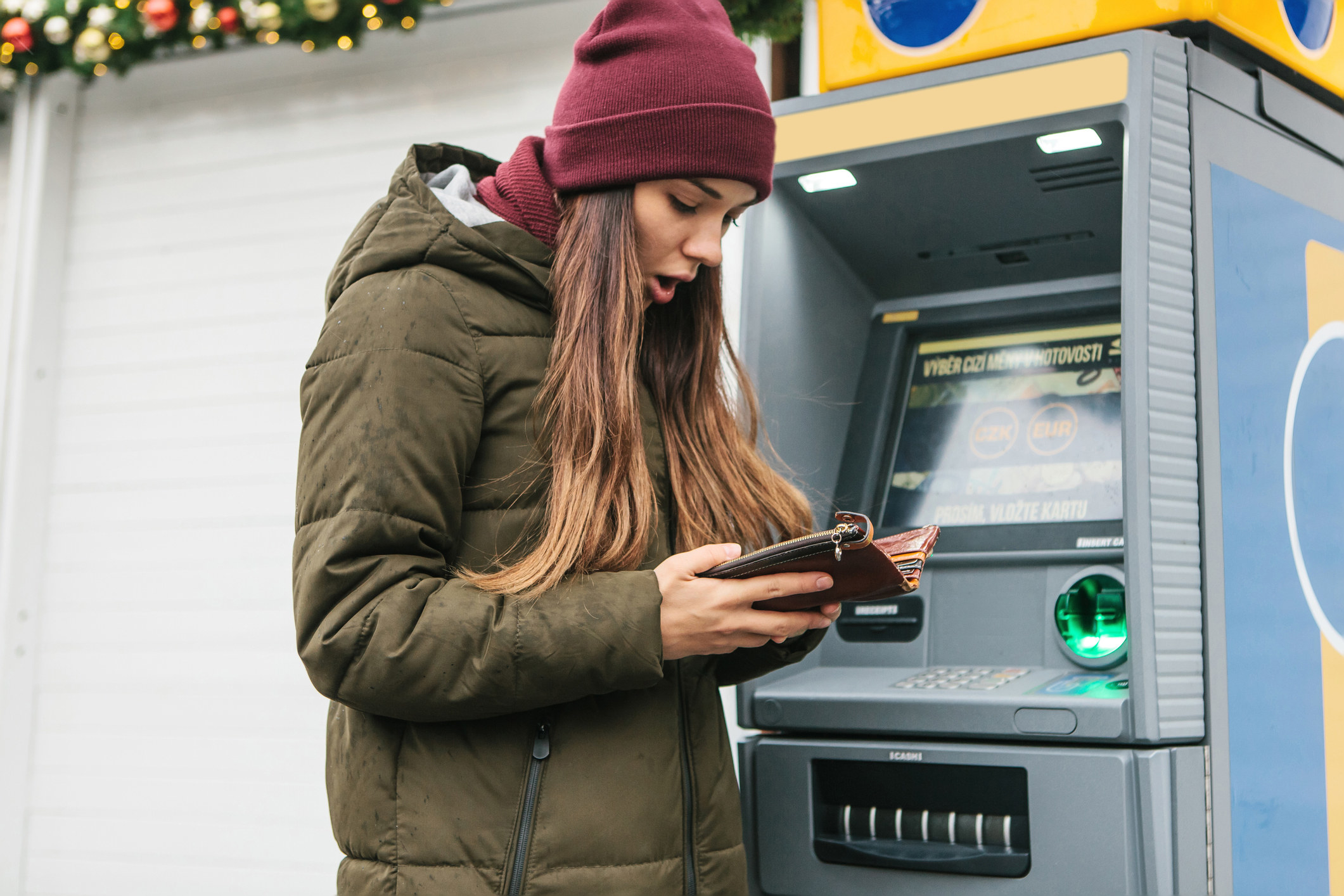 Person looking shocked opening their wallet