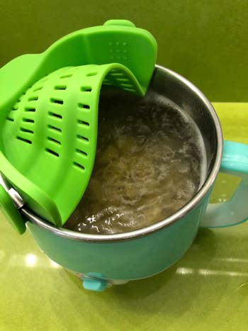 the strainer bent to fit a reviewer's small electric pot