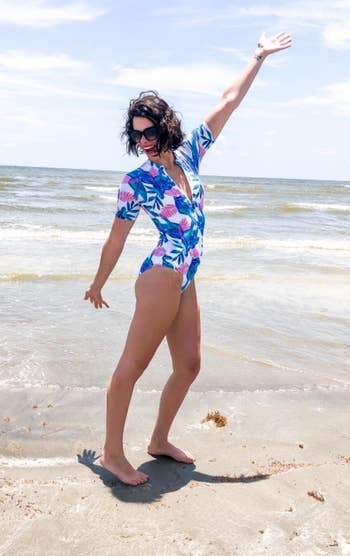 a different reviewer wearing the swimsuit in blue and pink leaf print