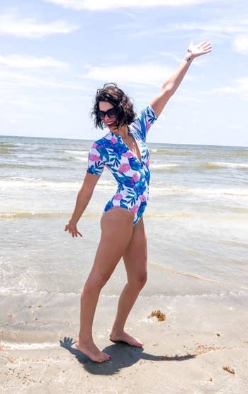 a different reviewer wearing the swimsuit in blue and pink leaf print
