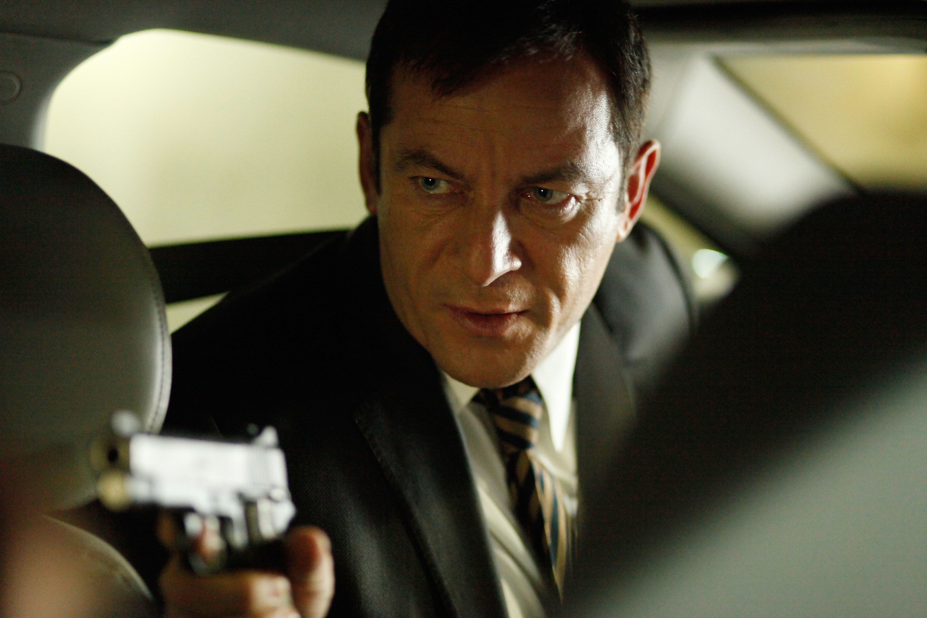 jason isaacs holding a gun