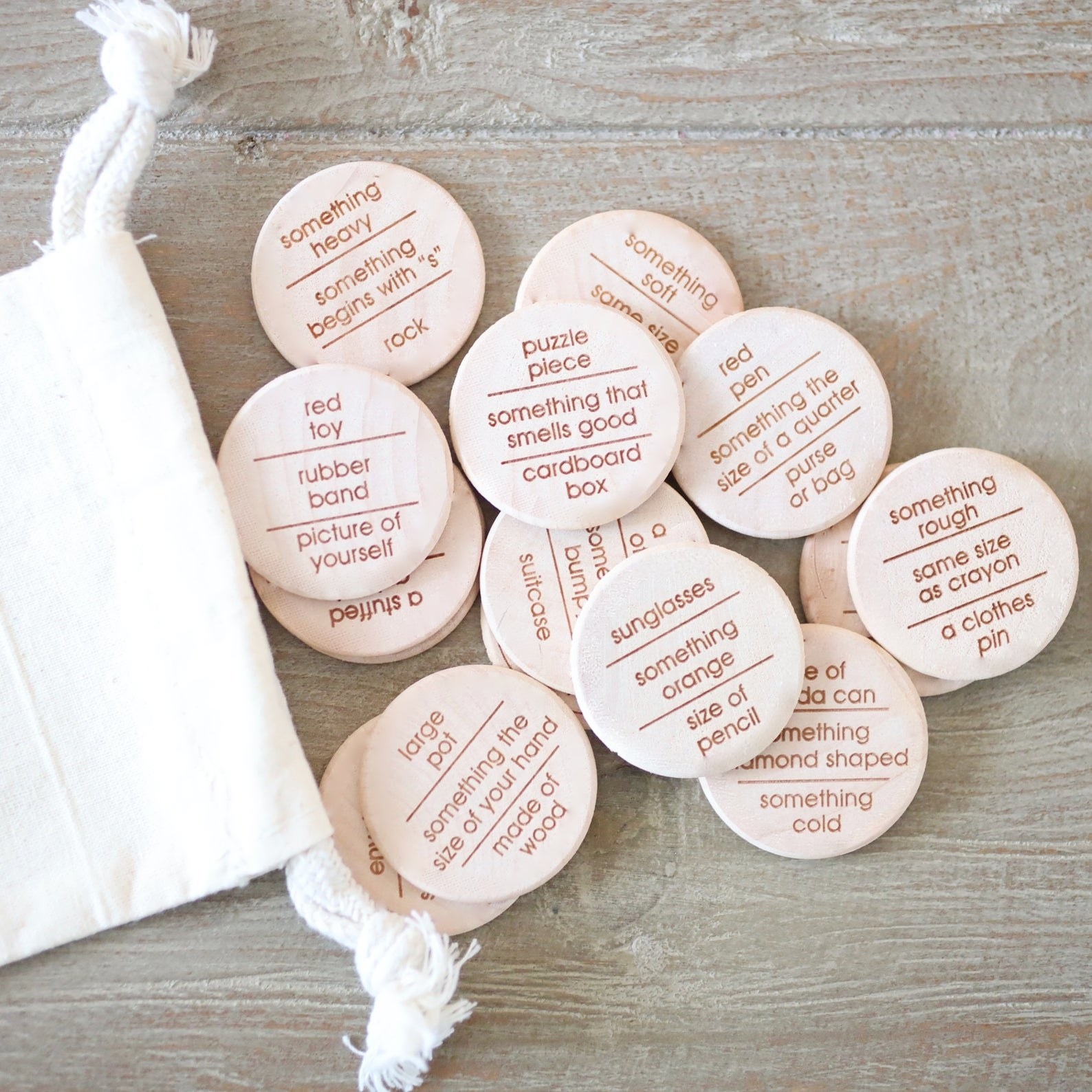 a pile of wooden circular tokens with different clues written on them